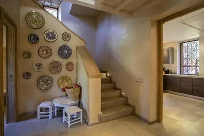 a hallway with plates on the wall and a staircase at Villa Atlas de Luxe avec piscine privée Domaine des Kasbahs in Marrakech