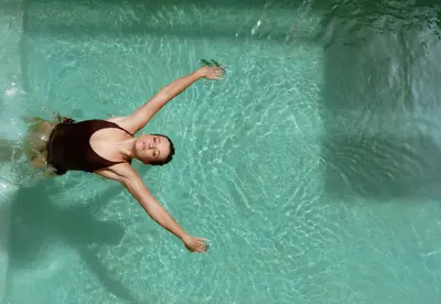 a woman swimming in a pool in the water at La Brillante Marrakech in Marrakech