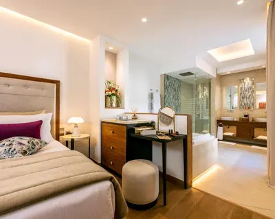 a bedroom with a bed and a sink and a bathroom at La Brillante Marrakech in Marrakech