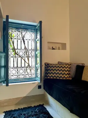 a living room with a window and a couch at Dar Titrit in Marrakech