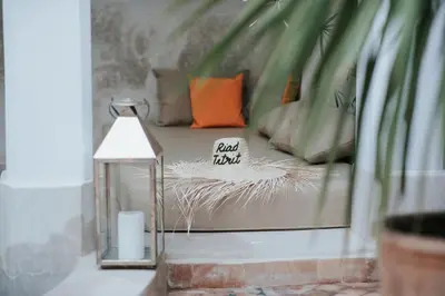 a room with a bed with a sign on it at Dar Titrit in Marrakech