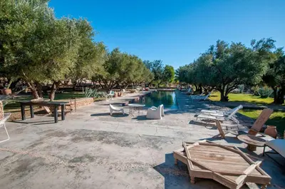 a group of tables and chairs next to a pool at SA FONDA in Tameslouht
