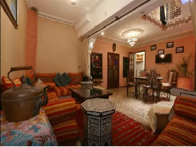 a living room with a couch and a table at Riad Maison Aicha in Marrakech
