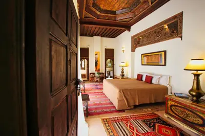 a hotel room with a bed and a door at Riad du Ciel Marrakech in Marrakech