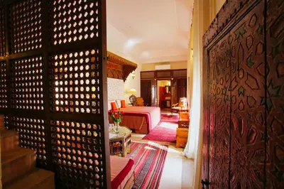 a bedroom with a bed and a room with a door at Riad du Ciel Marrakech in Marrakech