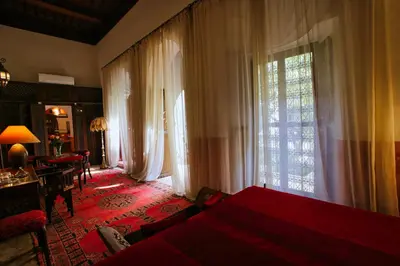 a bedroom with a bed and a large window at Riad du Ciel Marrakech in Marrakech
