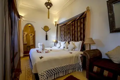 a bedroom with a bed with two stuffed animals on it at Riad Anabel in Marrakech