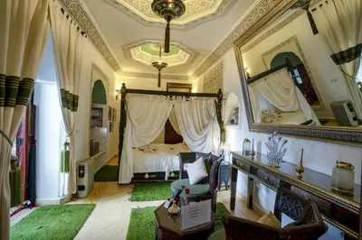 a bedroom with a bed and a large mirror at Riad Anabel in Marrakech