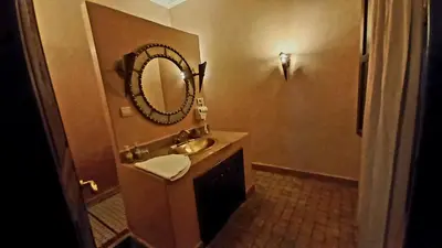 a bathroom with a sink and a mirror at Riad Rêve d Antan in Marrakech