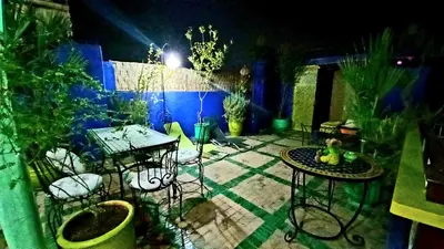 a patio with a table and chairs and plants at Riad Rêve d Antan in Marrakech