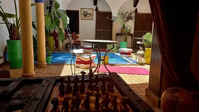 a room with a chessboard and a table in a room at Riad Rêve d Antan in Marrakech