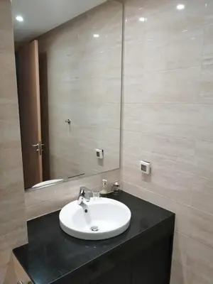 a bathroom with a sink and a mirror at Prestigia Marrakech Village Appartment in Marrakech