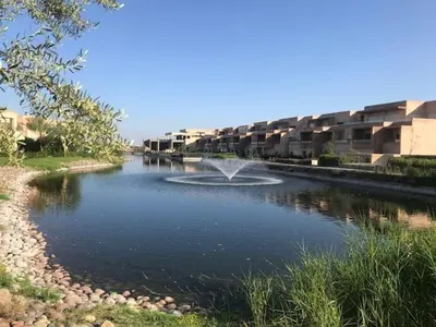 a fountain in the middle of a river at Prestigia Marrakech Village Appartment in Marrakech