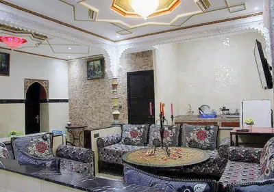 a living room with a table and chairs at Miramare Marrakech in Marrakech