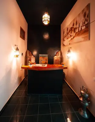 a bar in a room with lights on the wall at Riad O LY in Marrakech