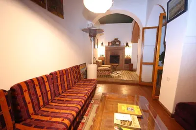 a living room with a couch and a fireplace at Riad O LY in Marrakech