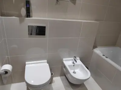 a white bathroom with a toilet and a sink at Magnifique appart vue sur golf in Marrakech
