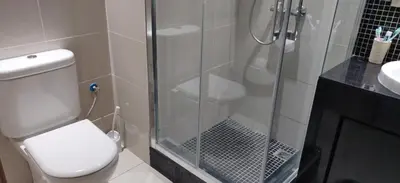 a bathroom with a shower and a toilet and a sink at Magnifique appart vue sur golf in Marrakech