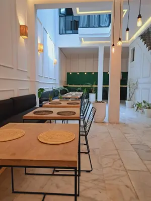 a row of tables and chairs in a room at Riad Aïcha Kitchen in Marrakech