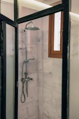 a shower with a shower head in a bathroom at Riad Aïcha Kitchen in Marrakech