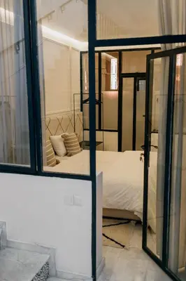 a bedroom with a bed and a mirror at Riad Aïcha Kitchen in Marrakech