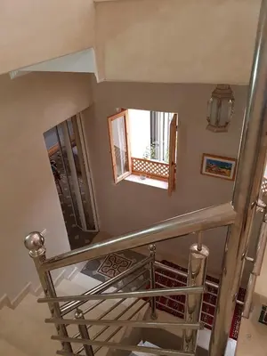 a spiral staircase in a building with a window at Riad Espressino exclusive Marrakech in Marrakech