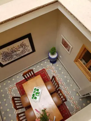 an overhead view of a dining room with a table and chairs at Riad Espressino exclusive Marrakech in Marrakech