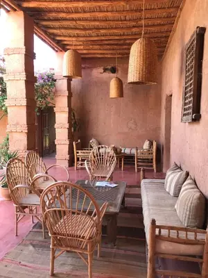 a patio with chairs and a table and a couch at La Ferme Berbere in Marrakech