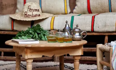 a coffee table with two glasses and a tea kettle at La Ferme Berbere in Marrakech