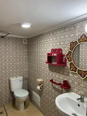 a bathroom with a toilet and a sink and a mirror at Riad Mahjouba Marrakech & SPA in Marrakech