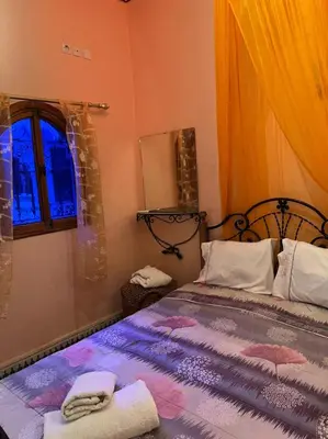 a bedroom with a bed with towels on it at Riad Mahjouba Marrakech & SPA in Marrakech