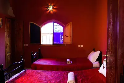a bedroom with two beds and a window at Riad Mahjouba Marrakech & SPA in Marrakech