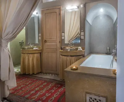 a large bathroom with two sinks and a tub at Riad Azoulay in Marrakech