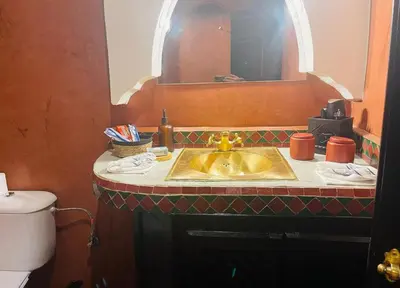 a bathroom with a sink and a toilet at Riad Bjoujna in Marrakech