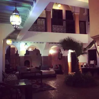 a living room with a large building with a palm tree at Riad Bjoujna in Marrakech