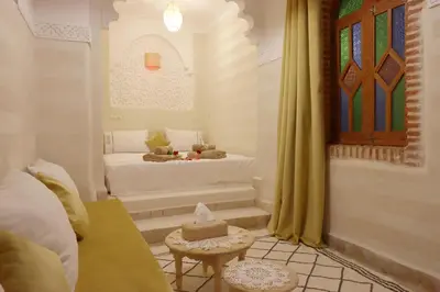 a room with a bed and a table in a room at Riad Venezia in Marrakech
