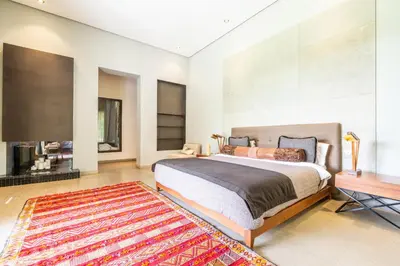 a bedroom with a large bed and a television at Zagora and Marhba villas Marrakech - by EMERALD STAY in Marrakech