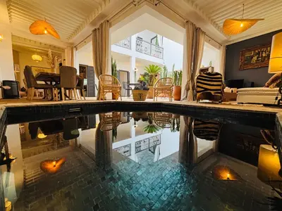 a house with a swimming pool in the middle of a room at Riad Instant T in Marrakech