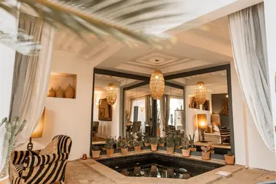 a living room with a large mirror and a tub at Riad Instant T in Marrakech