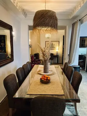 a dining room with a table with a bowl of fruit at Riad Instant T in Marrakech