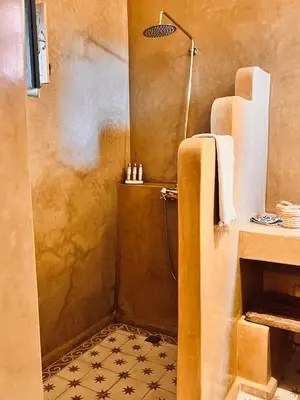 a bathroom with a shower with a sink and a shower at Riad Instant T in Marrakech
