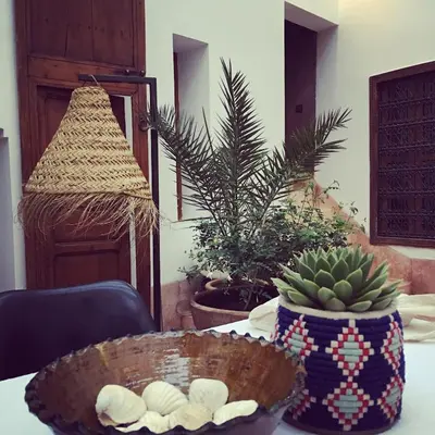 a table with a bowl and a plant on it at Riad UP in Marrakech