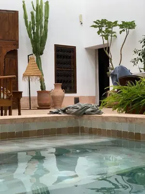 a swimming pool in a yard with plants at Riad UP in Marrakech