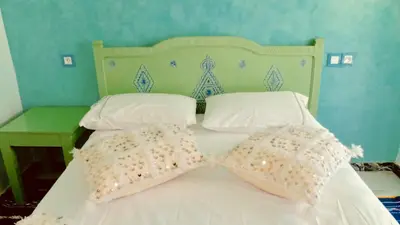 a white bed with two pillows and a headboard at Stylish Moroccan Apartment Gueliz City Centre in Marrakech