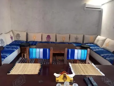 a living room with a couch and a table and chairs at Stylish Moroccan Apartment Gueliz City Centre in Marrakech