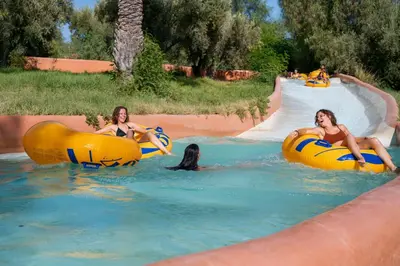 a group of women riding on tubes in the water at Oasis lodges in Marrakech