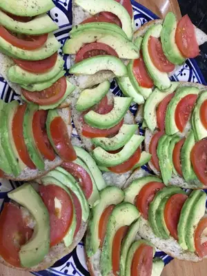 a group of sandwiches with avocado and tomatoes on a plate at Riad Orange in Marrakech