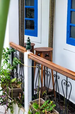 a porch with a blue door and some plants at Riad Bobby Marrakech in Marrakech