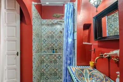 a bathroom with a shower and a sink at Riad Bobby Marrakech in Marrakech