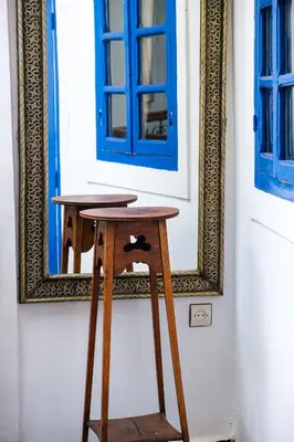a stool in front of a mirror in front of a door at Riad Bobby Marrakech in Marrakech